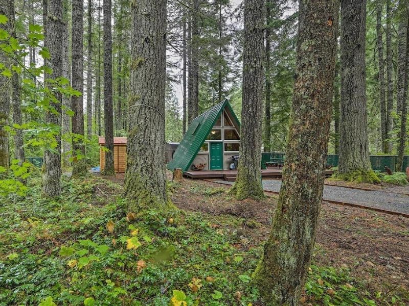 An A-frame cabin in the woods that makes up a guide to the coziest Mt Rainier cabins.