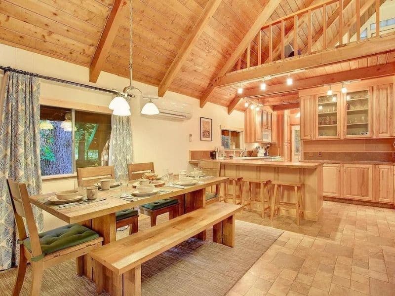 Clean and simple interior of wood cabin near Mt Rainier with dining table and open kitchen