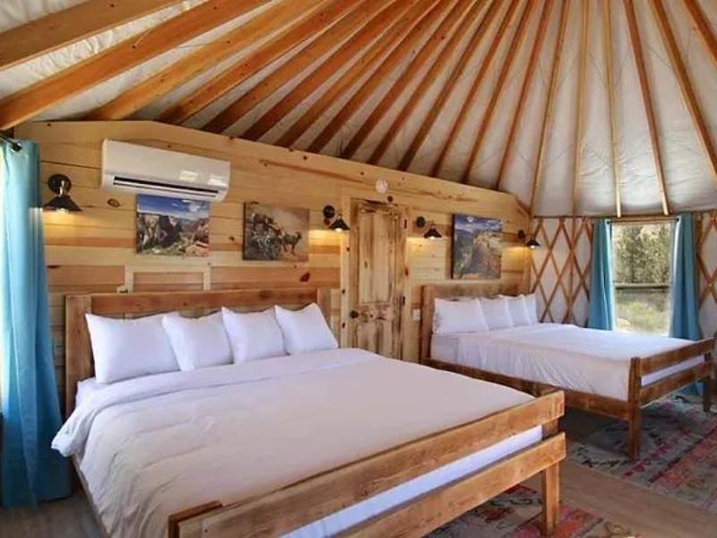 Interior of glamping yurt at East Zion Resort near Zion National Park with two double beds and A/C