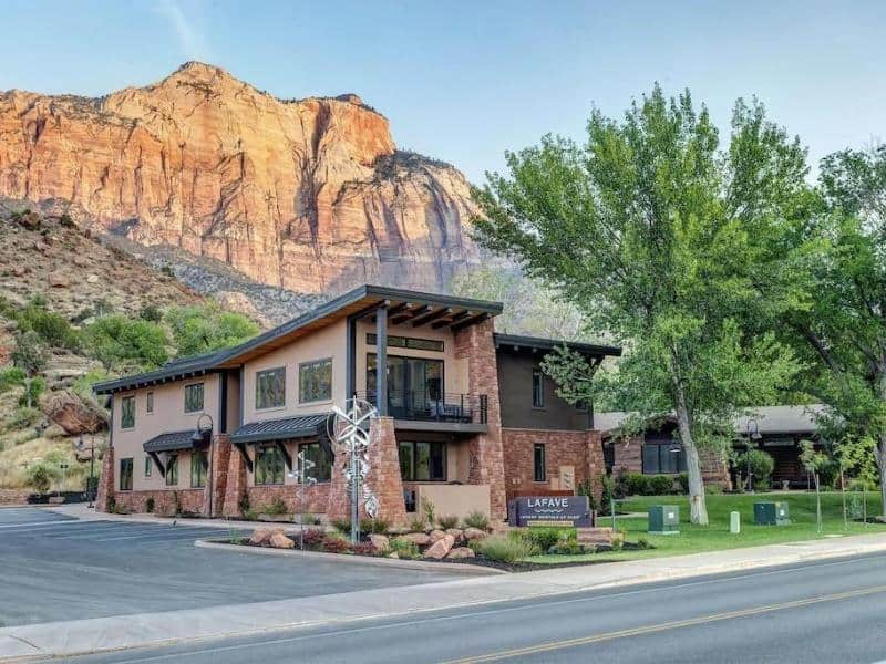 Exterior of La Fave Luxury Rentals against Zion's red rocks. Zion lodging options