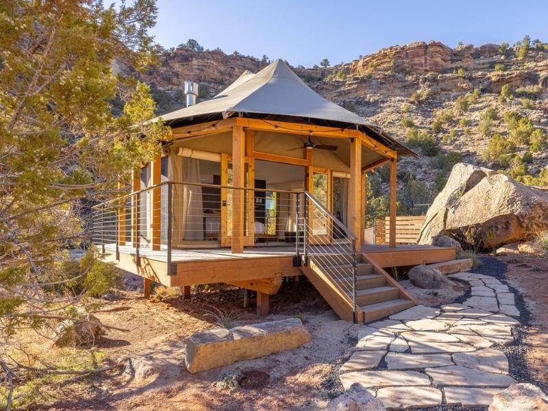 Exterior of luxury glamping tent near Zion National Park at Open Sky Glamping with raised wooden deck and stairs leading to the entrance