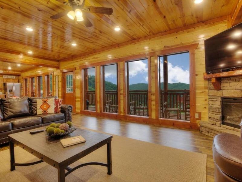 Living area with floor to ceiling windows in large cabin rental in Pigeon Forge