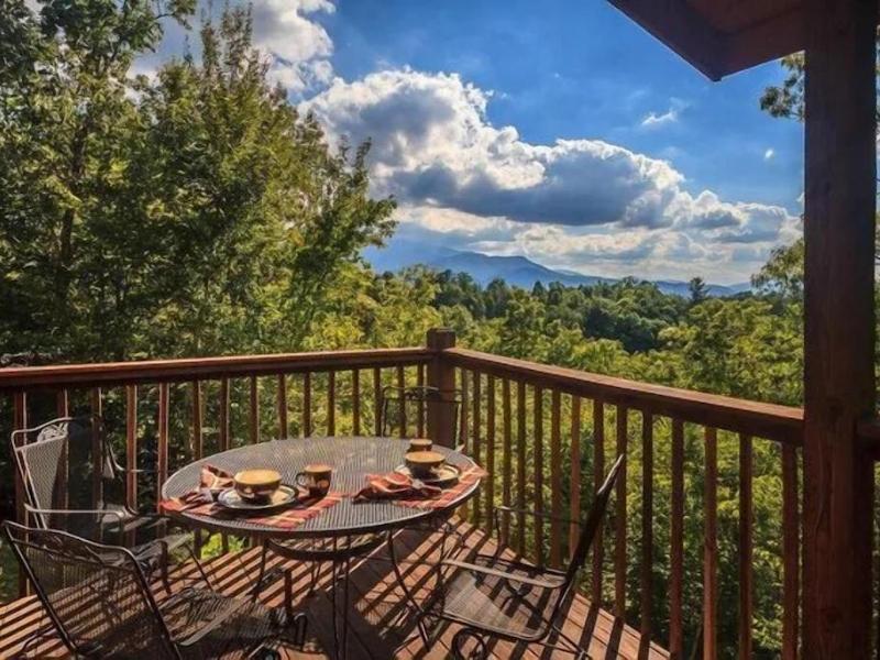 Small table with chairs on a deck at a Vrbo cabin in Pigeon Forge TN overlooking the Great Smoky Mountains