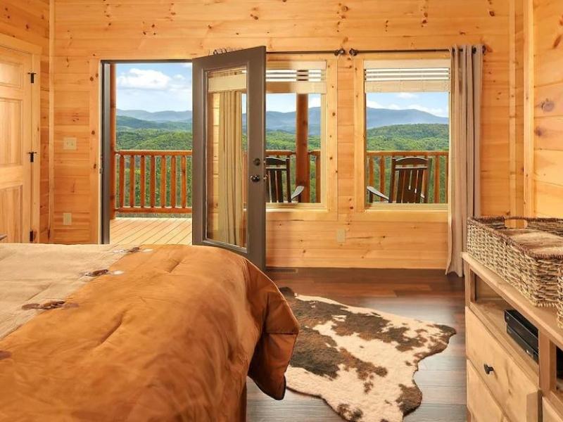 Large bedroom in Pigeon Forge cabin with direct access to deck and amazing Great Smoky Mountain views