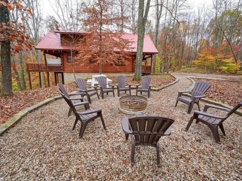 Luxury wood cabin in Hocking Hills Ohio with outdoor seating and a fire pit