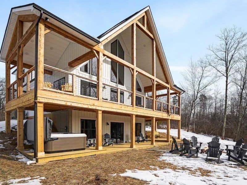 Large luxury Hocking Hills cabin rental with hot tub, wrap-around deck, and outdoor seating