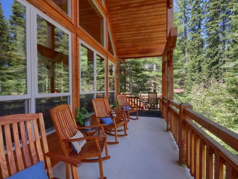 Outdoor deck with rocking chairs at a cabin rental in Yosemite, CA