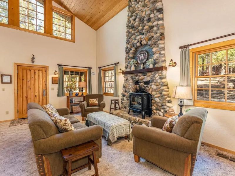 Living area with stone fireplace at dog friendly rental in Yosemite