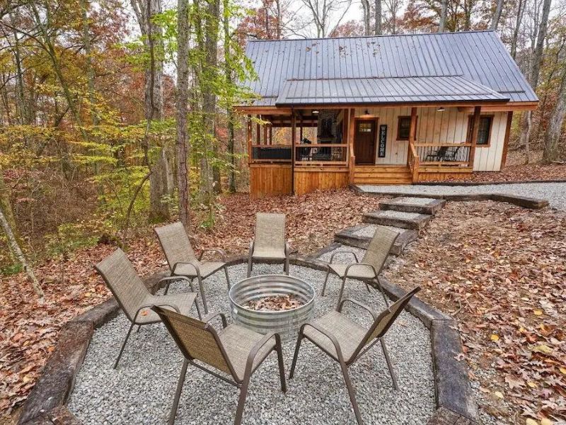 Firepit with chairs outside cozy farmhouse cottage - Hocking Hills Cabins for 2