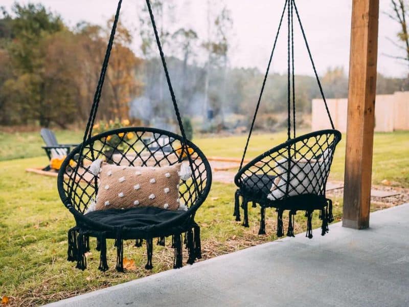 Swings on porch at Hocking Hills shipping container Vrbo 