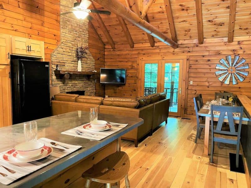 Interior living area with fireplace at log cabin in Hocking Hills, OH