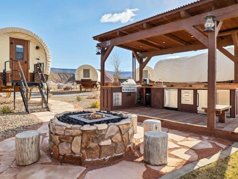 Outdoor kitchen and fire pit at a unit at Zion White Bison Glamping