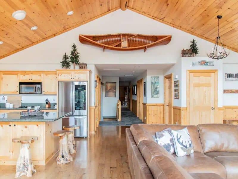Modern-rustic luxury cabin in Big Bear with wood finishes and large leather couch