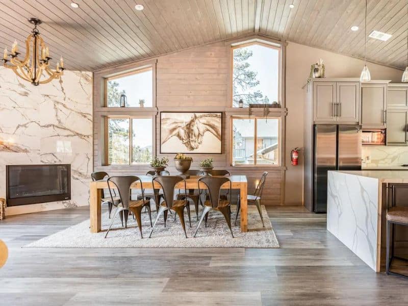 Contemporary dining and living area with fireplace at upscale Big Bear vacation rental
