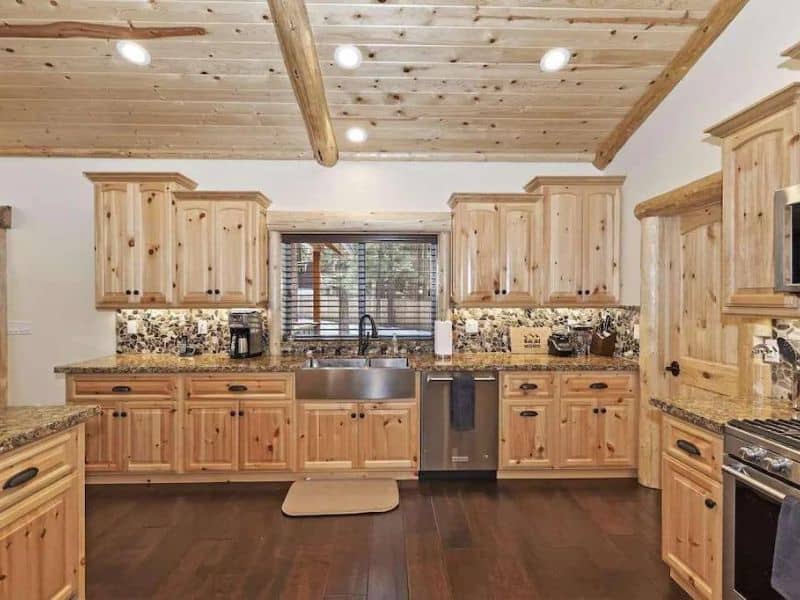 Large modern wood kitchen with stainless steel appliances at cabin rental in Big Bear CA