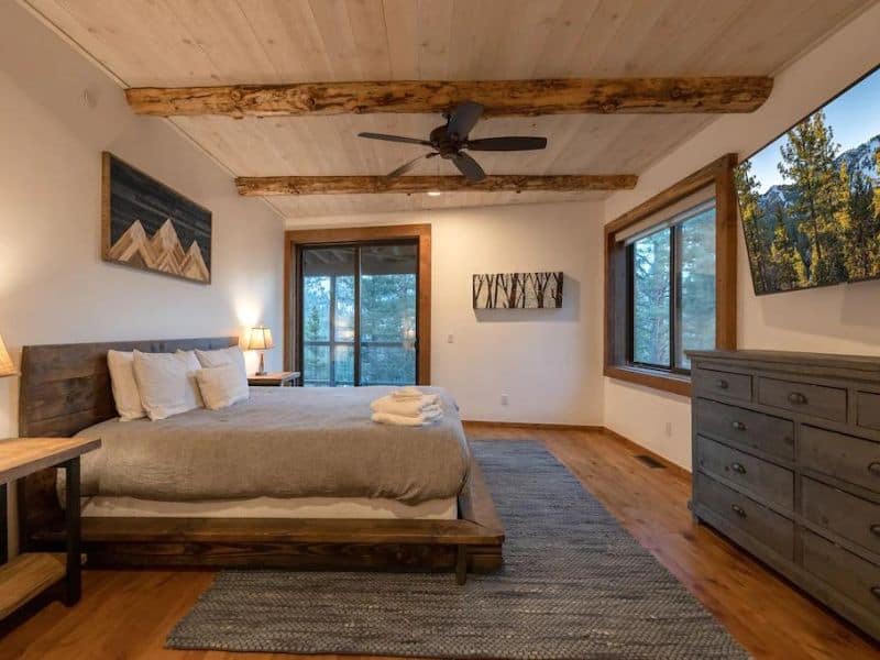 Large bedroom would king bed and exposed beam ceilings in Big Bear cabin