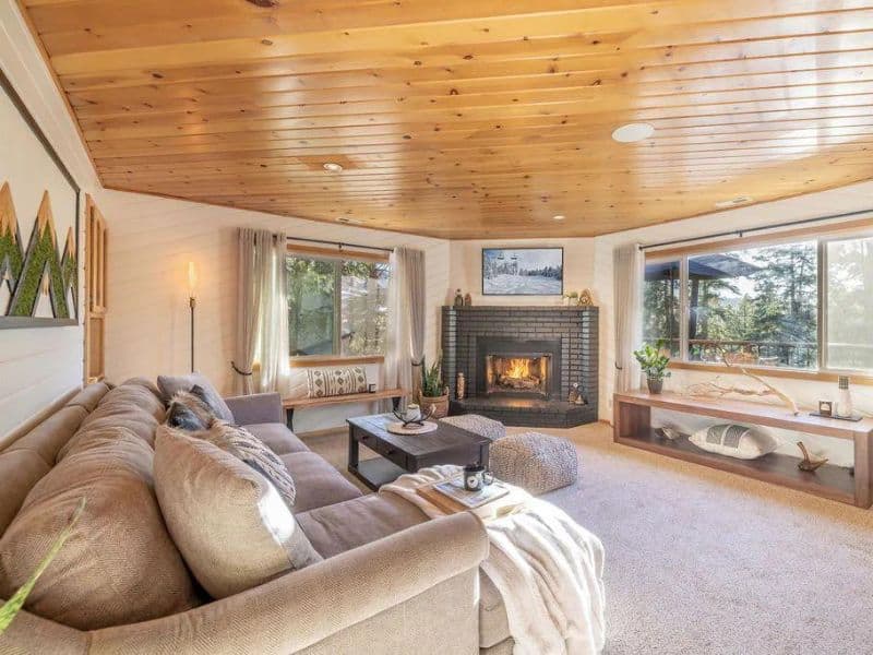 Living area with fireplace in modern cozy Big Bear cabin rental near Bear Mountain Ski Resort
