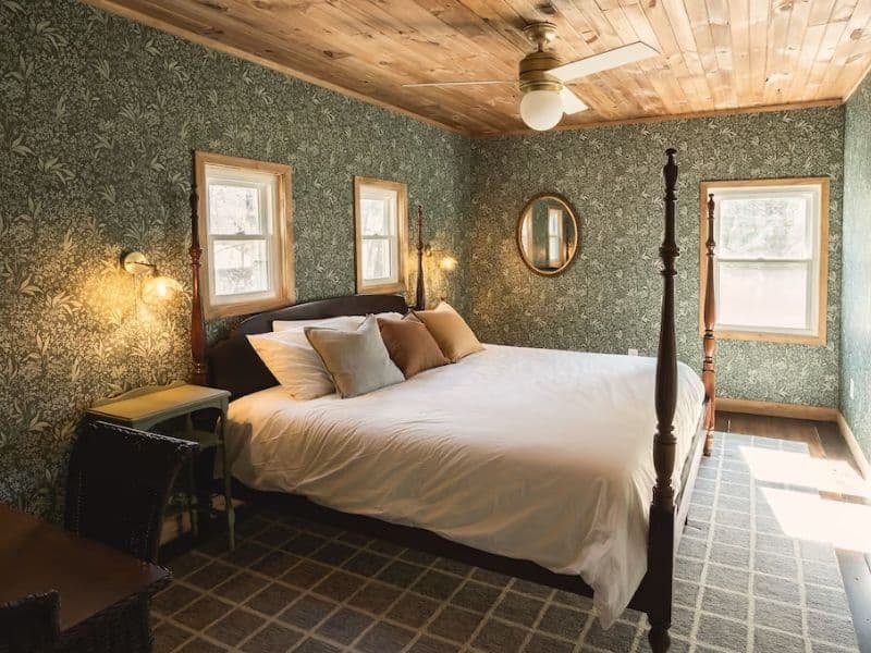 King master bedroom with teal wallpaper in Hocking Hills pet-friendly cottage rental