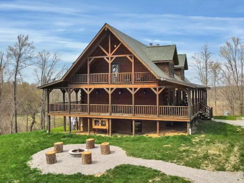 Two-story wood cabin in Hocking Hills with fire pit and log seating