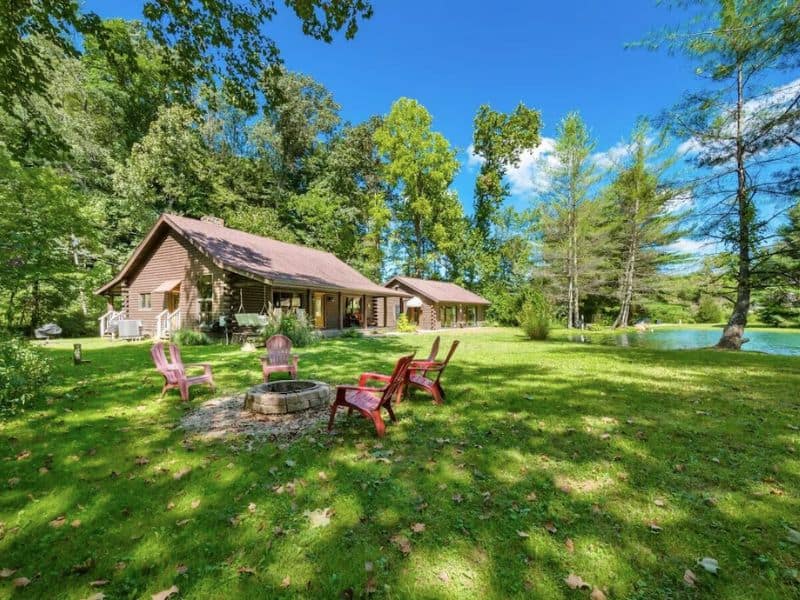 Exterior of Hocking Hills cabin rental with fire pit and pond