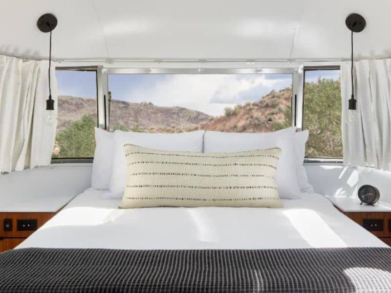 Luxury bed and bedding in AutoCamp Zion airstream trailer