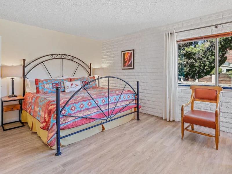 Bedroom of Sedona vacation home, with white block walls and colorful decor.