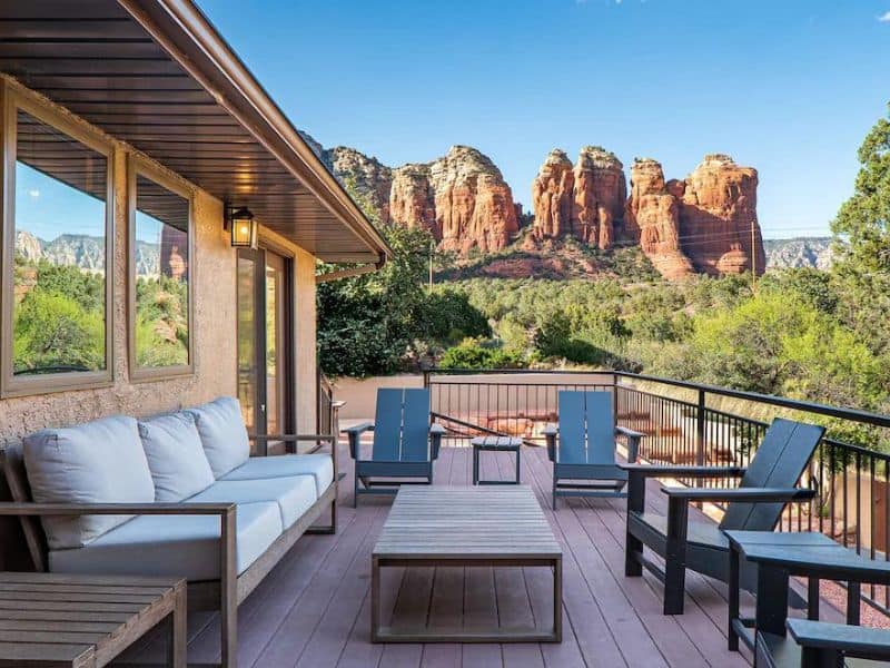 porch with generous seating area, with views of red rock formations in Sedona home rental.