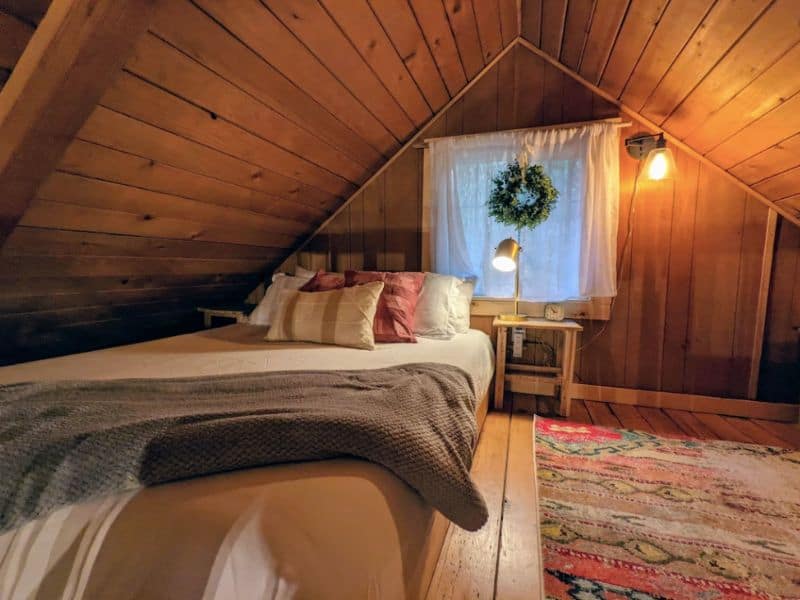 Cozy loft bedroom in wood cabin