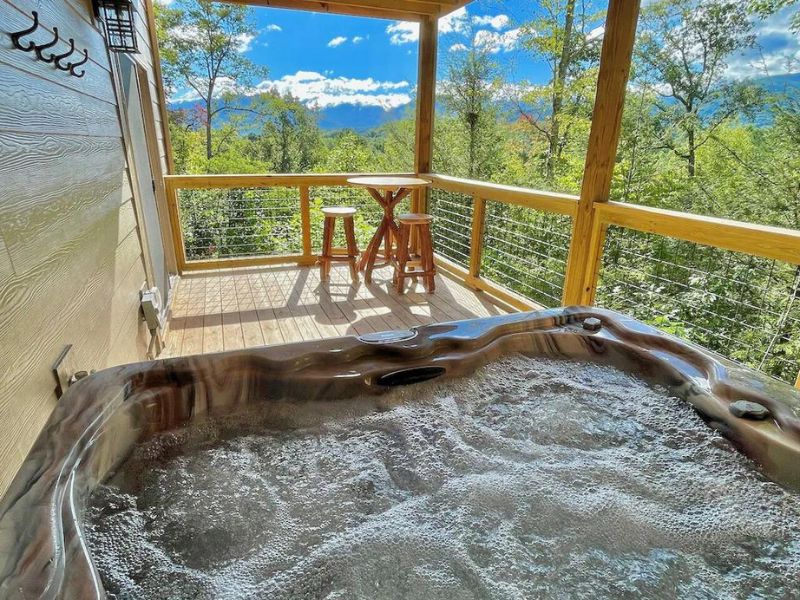 Hot tub on a covered deck overlooking Great Smoky Mountains