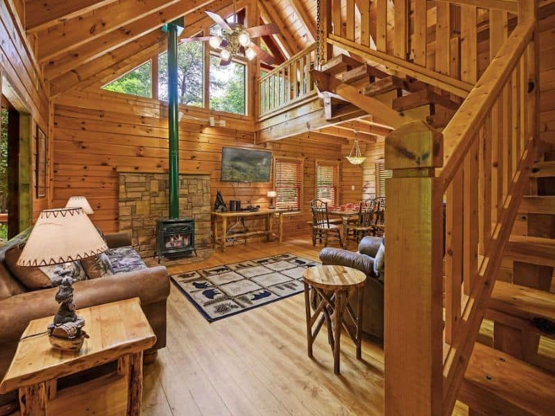 Open living area with wood burning fireplace in log cabin rental in Gatlinburg