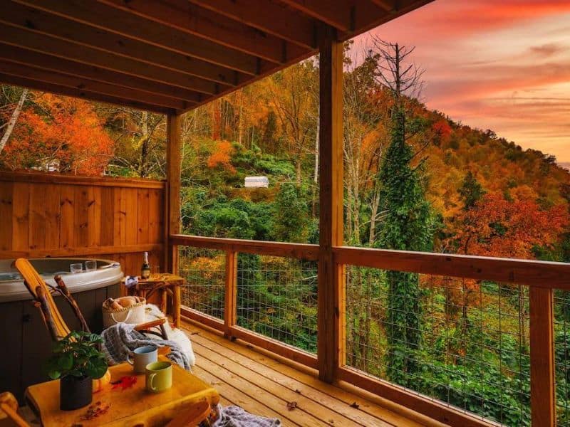 Covered wood deck with hot tub overlooking wooded area near Gatlinburg TN - part of a curated guide to the best dog-friendly cabins in Gatlinburg