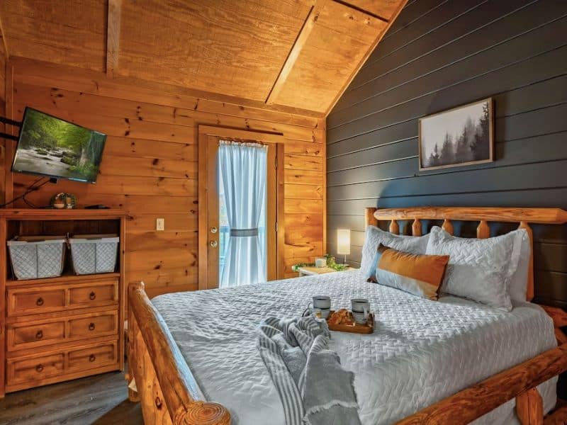Bedroom in Gatlinburg cabin with upscale finishes and wood accents