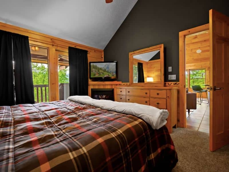 Bedroom in Gatlinburg pet-friendly cabin rental with plaid comforter  and TV