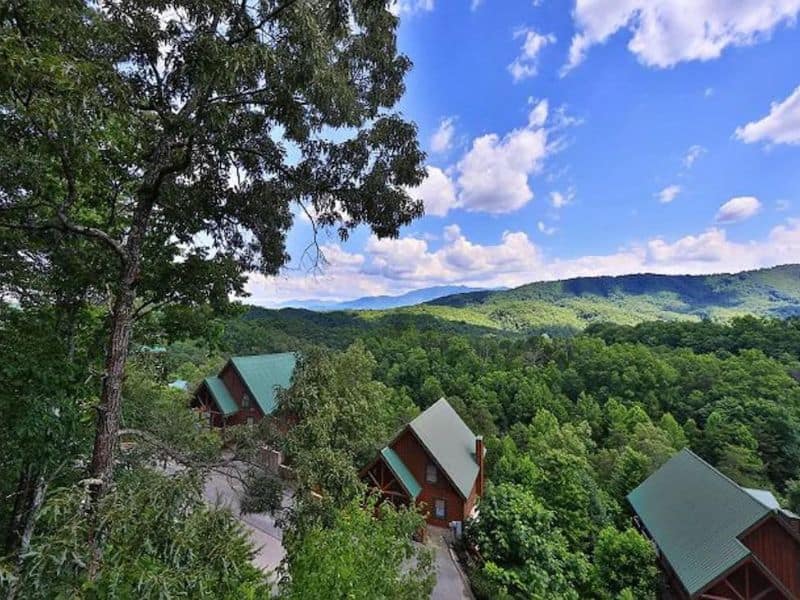 Aerial view of three cabin rentals in Gatlinburg surrounded by woodlands in the Great Smoky Mountains