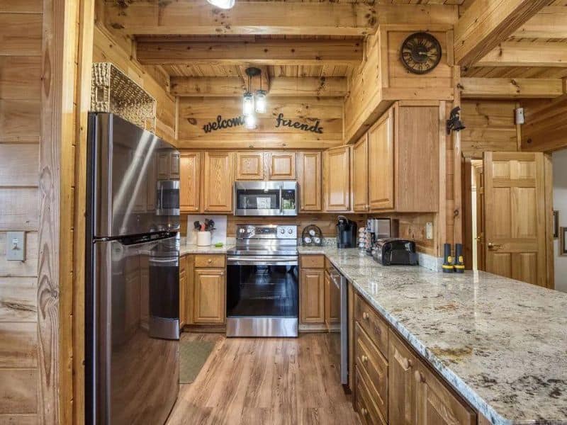 Modern rustic kitchen with wood finishes, stainless steel appliances, and granite countertops