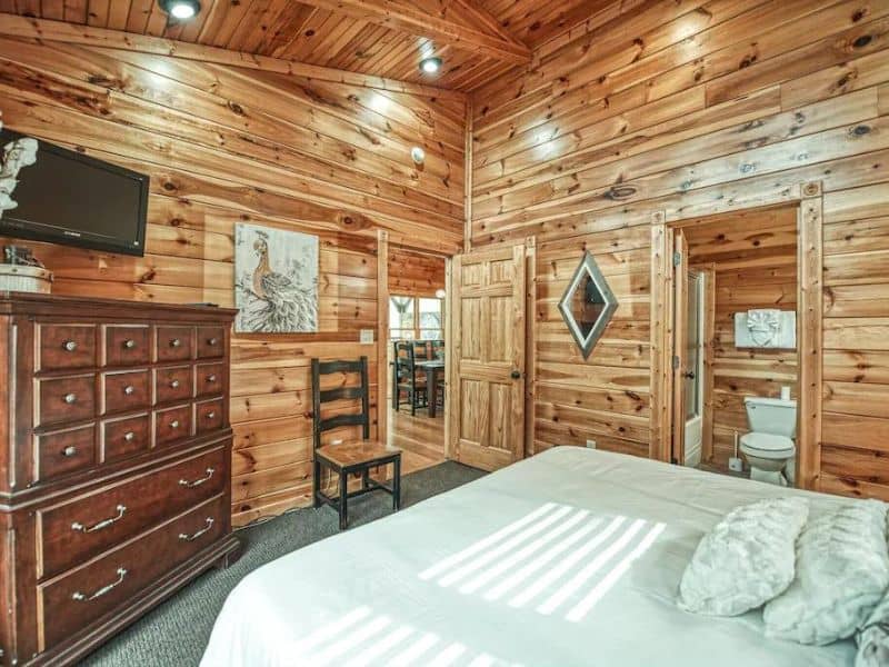 Bedroom in Gatlinburg cabin rental with wood finishes throughout
