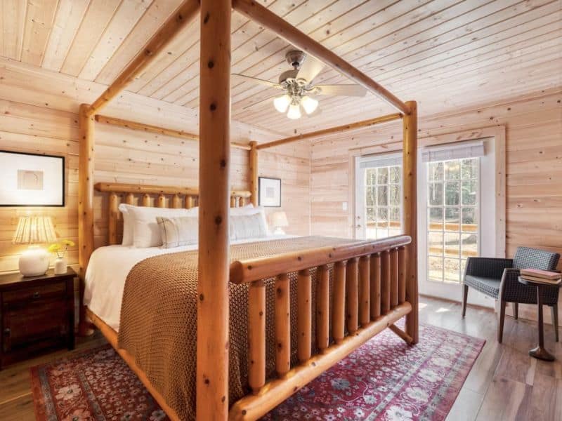 Large king-size bed in wood cabin rental in the Great Smoky Mountains