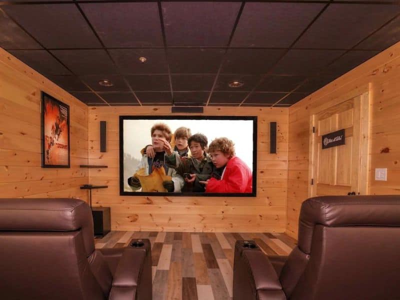 In-home private theater with plush platform seating and move screen at large Gatlinburg cabin rental