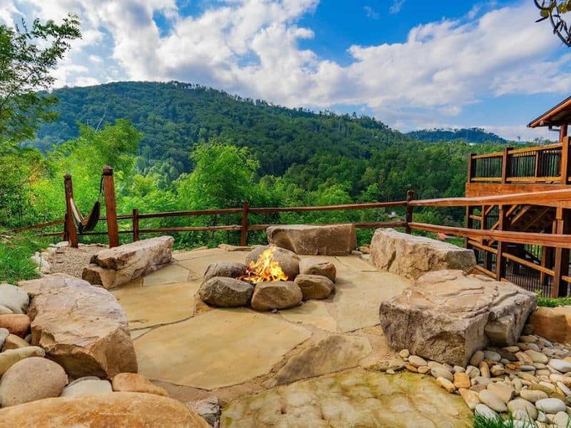 Outdoor fire pit with natural rock seating and views of the Great Smoky Mountains
