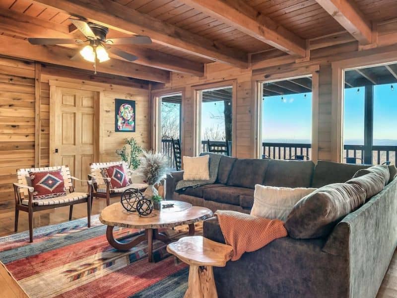 Interior living area of Gatlinburg vacation rental with couches, chairs and area rug