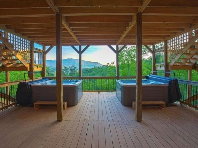 Two undercover hot tubs on a large deck at Gatlinburg vacation home.