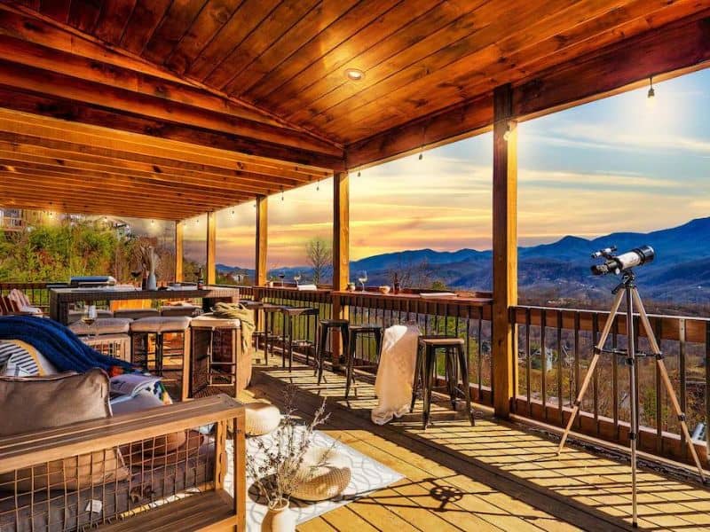 Large outdoor deck with bar seating and telescope overlooking the Great Smoky Mountains