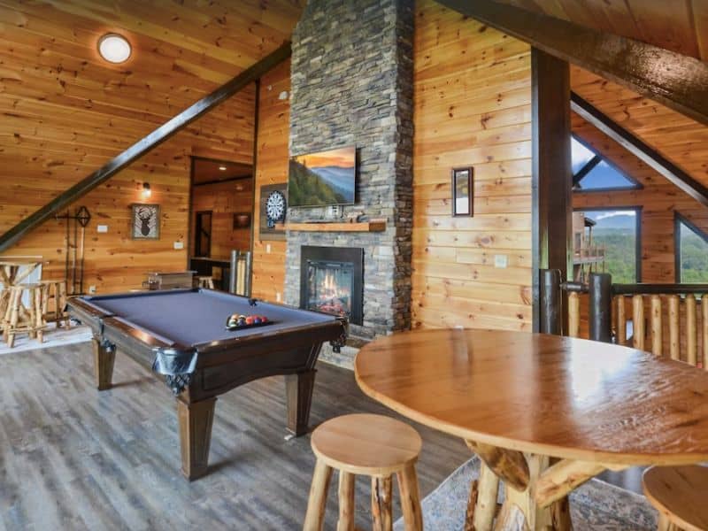 Open game room with fireplace and pool table in Gatlinburg vacation rental