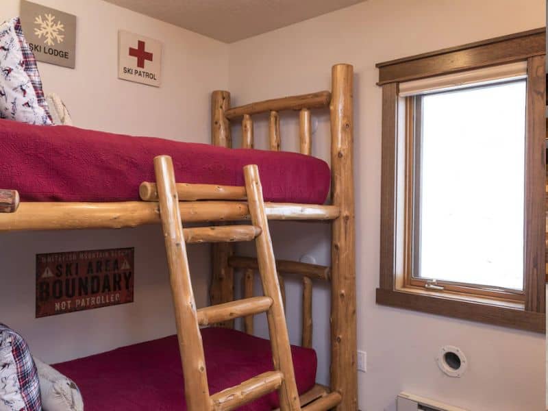 A Whitefish MT rental with a bunk bed in a room with a window.