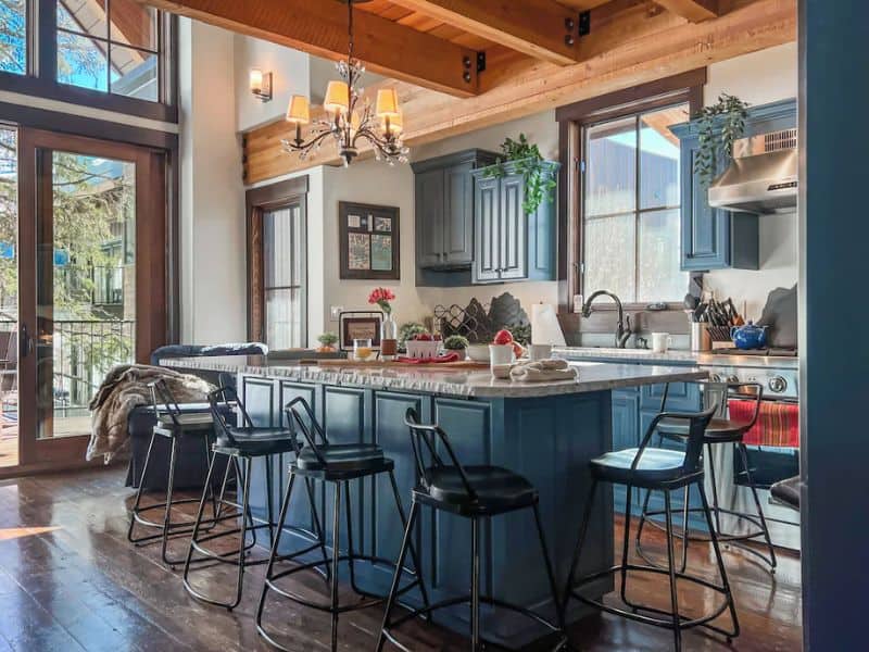 A kitchen in a Whitefish, Montana chalet rental with a large island and bar stools.