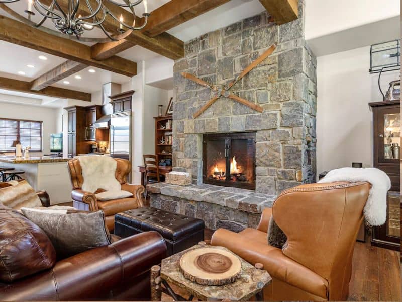 A Whitefish MT ski in ski out rental with a stone fireplace and leather furniture.
