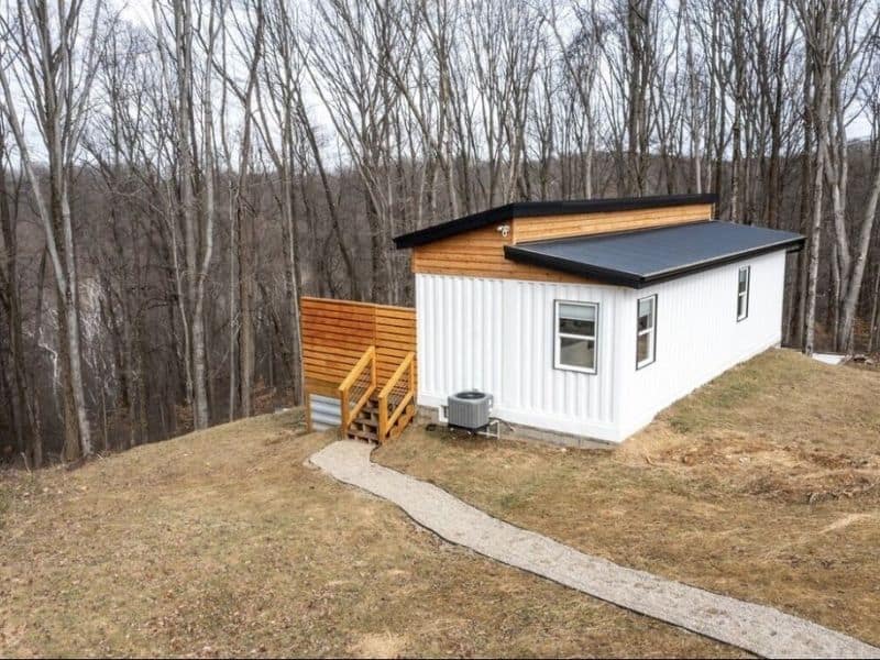A container cabin sits on top of a hill in the woods in Hocking Hills.