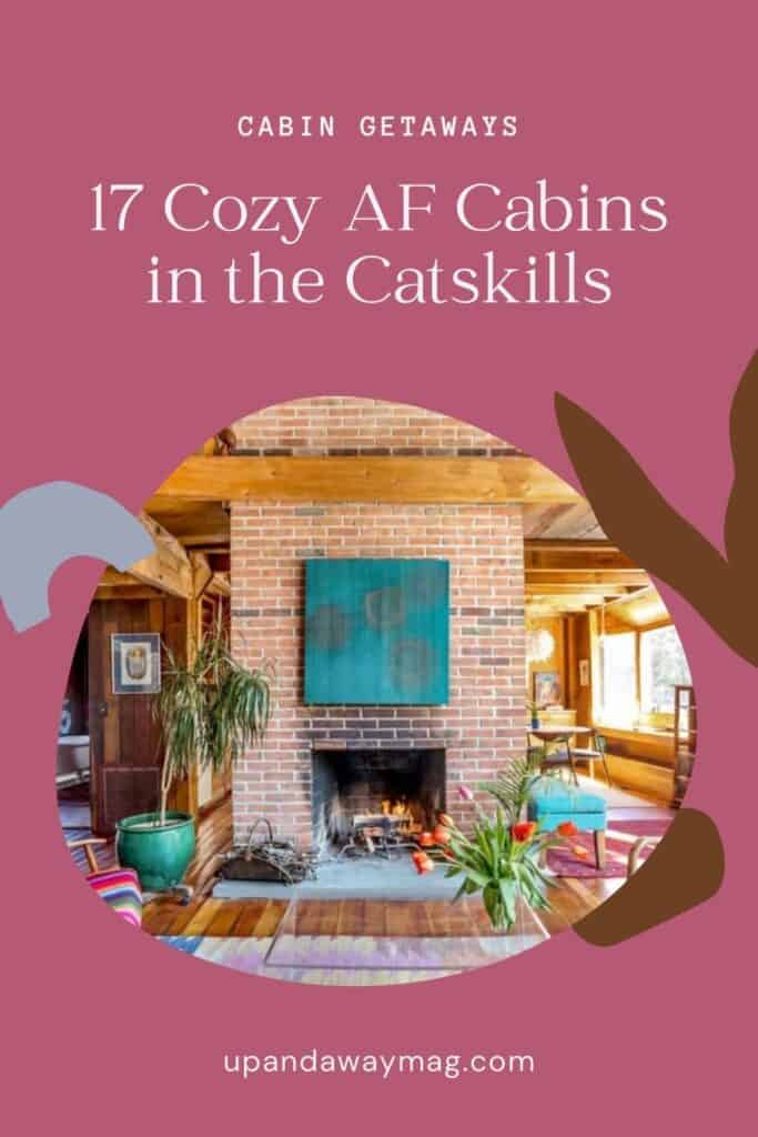 Pinterest graphic for a blog post titled '17 Cozy AF Cabins in the Catskills,' featuring an image of a cabin's interior with a brick fireplace, wood flooring, and a link to upandawaymag.com.