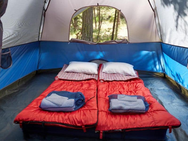 Inside view of a custom camping tent at Evergreen Lodge near Yosemite with comfortable bedding set up.