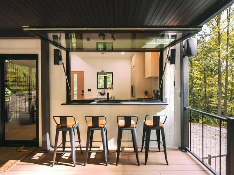 Outdoor kitchen bar at The Block Tower with seating for guests. Container home rental in Hocking Hills, OH.